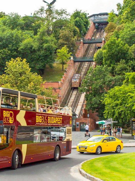 Budapest Big Bus tour near the funicular, with passengers enjoying the view.