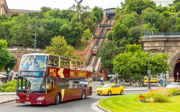 Budapest Big Bus tour near the funicular, with passengers enjoying the view.
