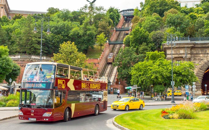 Budapest Big Bus tour near the funicular, with passengers enjoying the view.