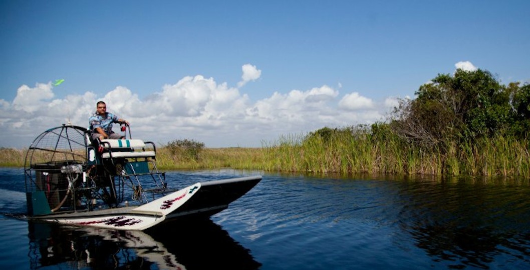 Airboat navigating through marshlands at Wild Florida.
