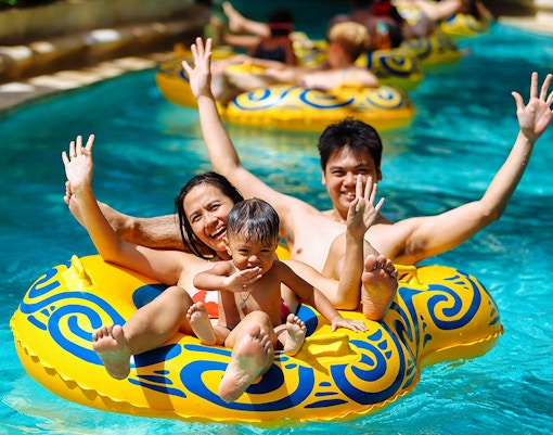 Family enjoying a lazy river ride at Splash Waterpark.