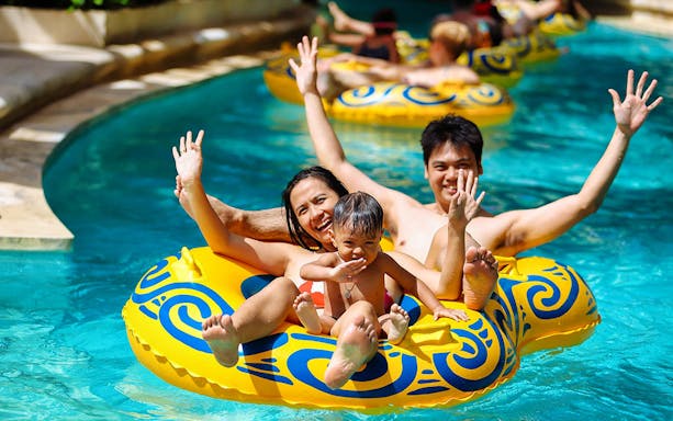 Family enjoying a lazy river ride at Splash Waterpark.