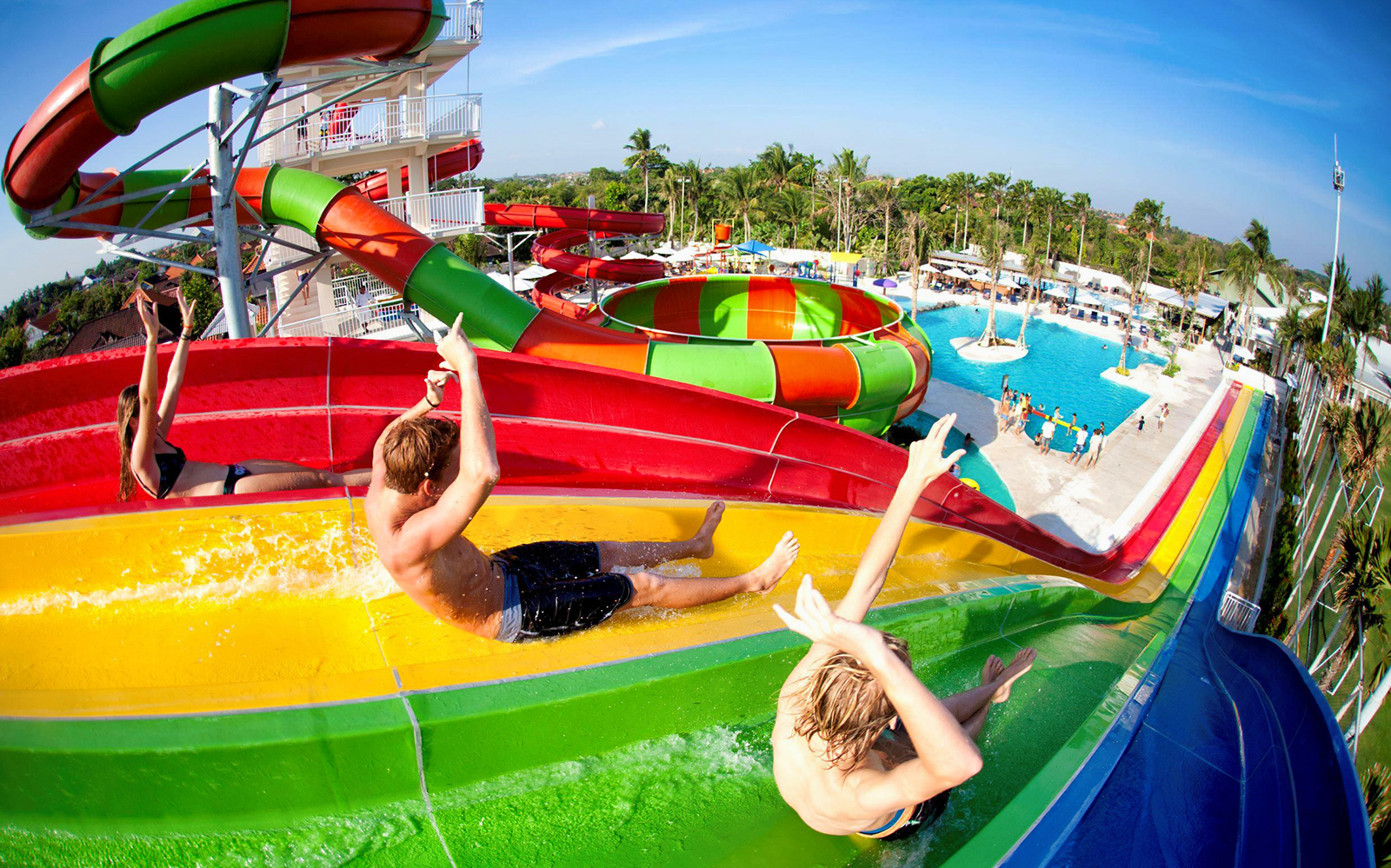 Visitors enjoying colorful water slides at Splash Waterpark.