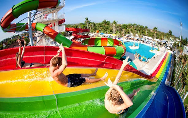 Visitors enjoying colorful water slides at Splash Waterpark.