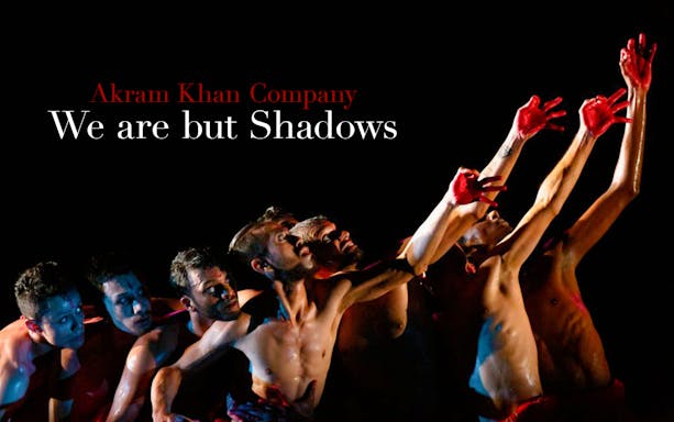 Dancers from Akram Khan Company performing "We are but Shadows" with red-painted hands.
