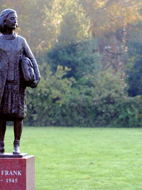Anne Frank statue in a park setting, Amsterdam.