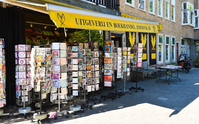 Bookstore with postcard racks in Amsterdam on Anne Frank Story & Neighbourhood Walking Tour.