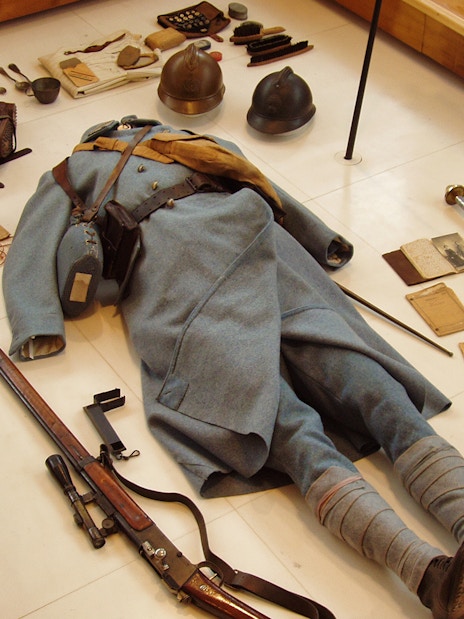 World War II soldier's uniform and equipment display at Normandy museum.
