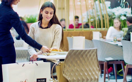 Shopping break at FoxTown Designer Outlet cafe during Milan tour.
