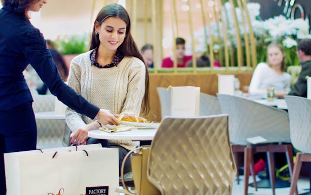 Shopping break at FoxTown Designer Outlet cafe during Milan tour.