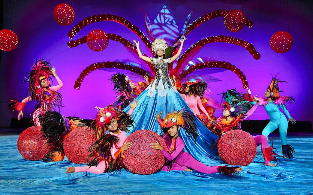 Performers in vibrant costumes at Bali Safari and Marine Park show.