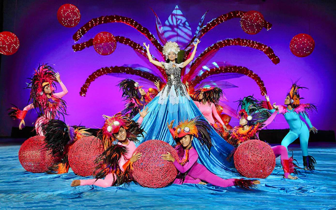 Performers in vibrant costumes at Bali Safari and Marine Park show.