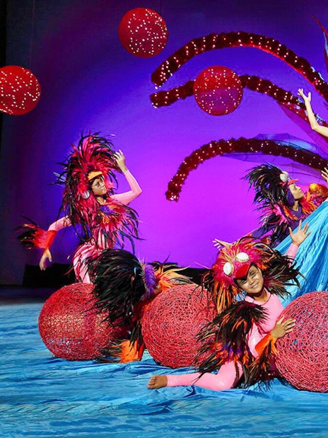 Performers in vibrant costumes at Bali Safari and Marine Park show.