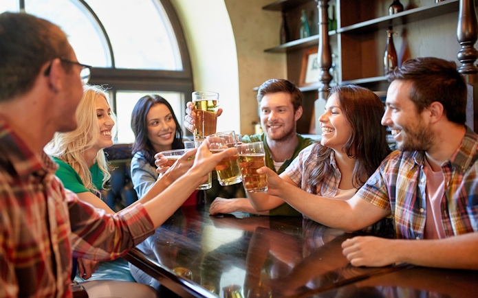Group of friends toasting with beer during a 3-hour beer tour.