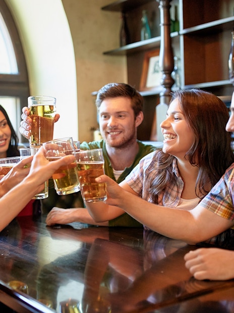 Group of friends toasting with beer during a 3-hour beer tour.