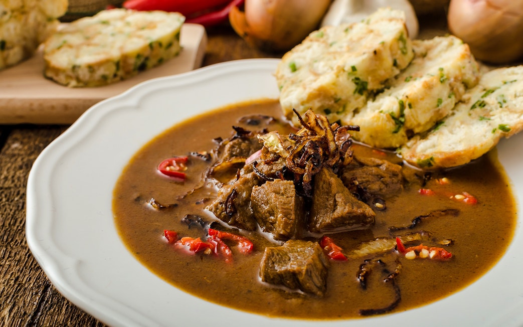 Beef goulash with dumplings served during a traditional dinner in Prague.