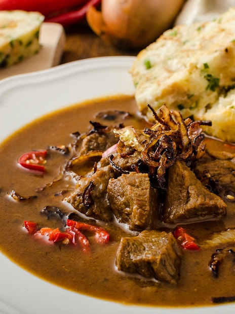 Beef goulash with dumplings served during a traditional dinner in Prague.