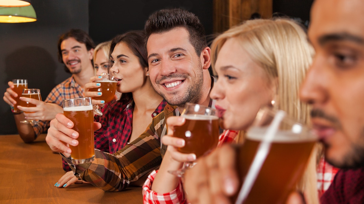 Tourists enjoying a beer tasting session in a traditional Prague pub during a 3-hour beer tour.