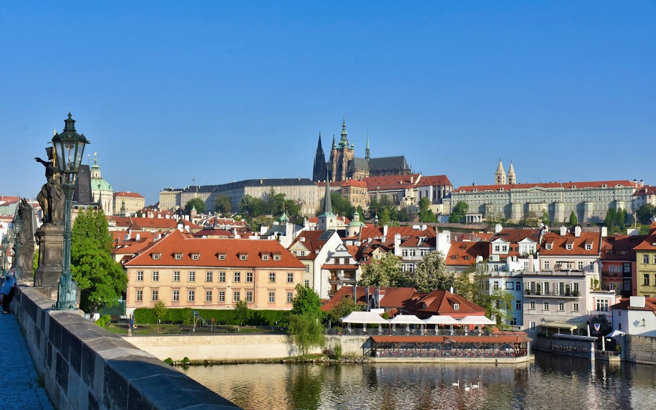 Prague cityscape with Charles Bridge and Prague Castle in the background.
