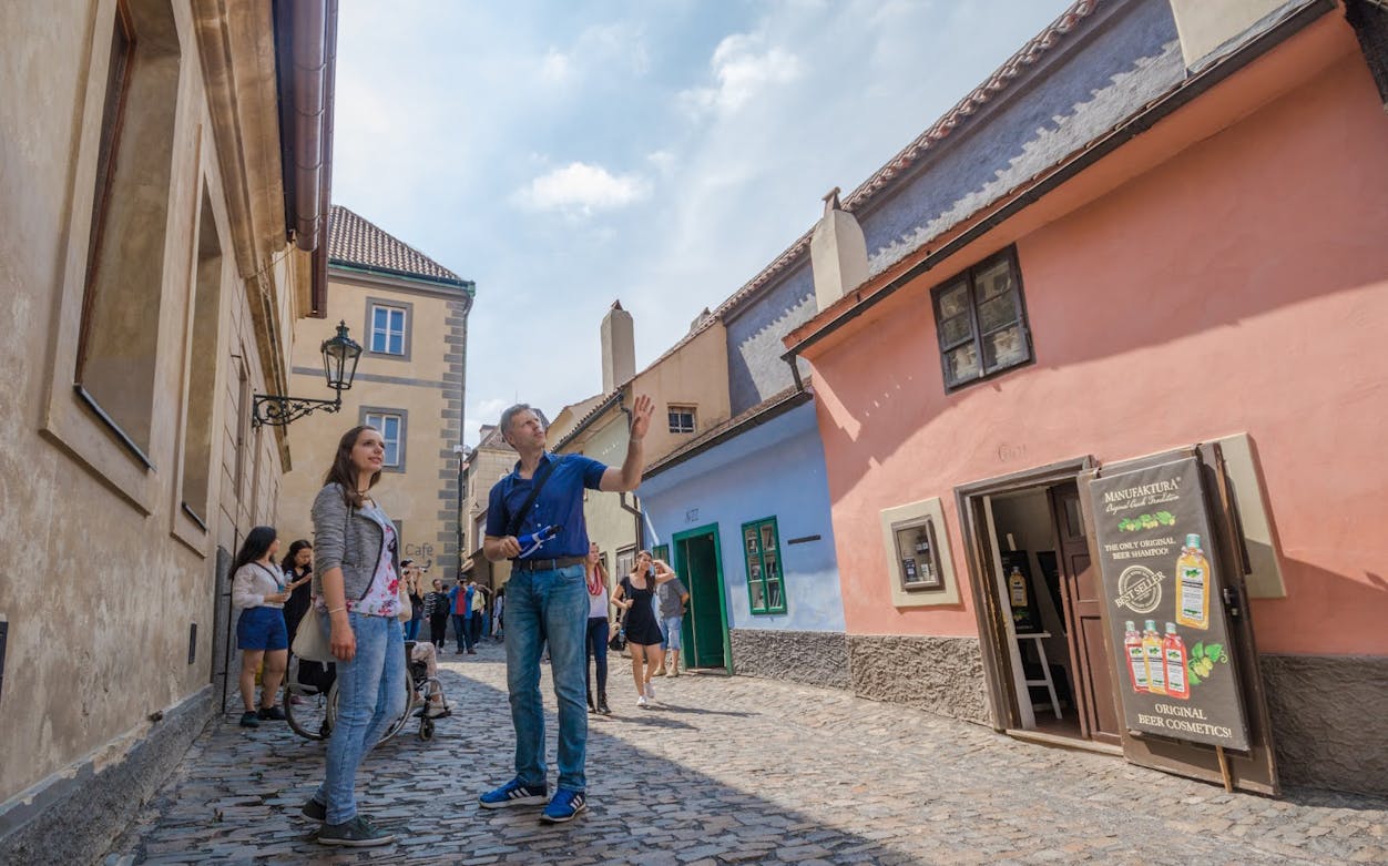 Tourists exploring Golden Lane in Prague during a city tour.