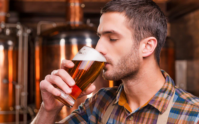 Man enjoying beer at a Prague brewery during a tour and tasting experience.