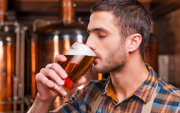 Man enjoying beer at a Prague brewery during a tour and tasting experience.