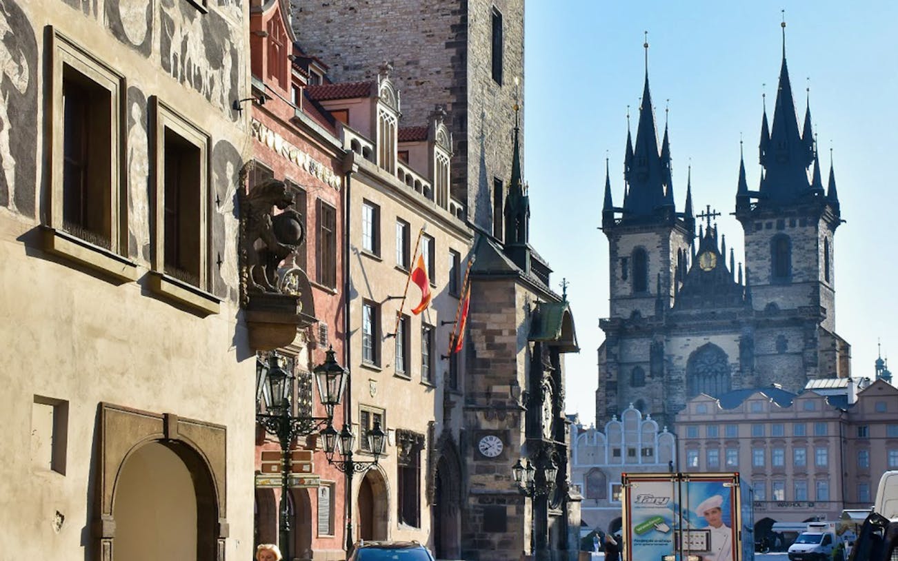 Prague street view with Tyn Church and historical buildings.