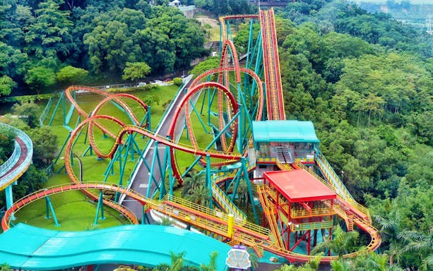 Roller coaster at Leofoo Village Theme Park surrounded by lush greenery.