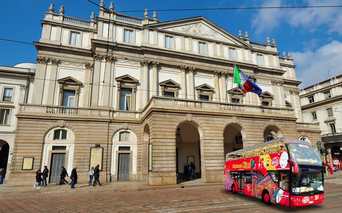 La Scala opera house with a red hop-on-hop-off tour bus in Milan, Italy.
