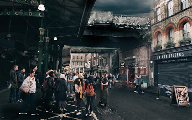 Group of tourists in Borough Market, London, during Magic of Film Experience tour.