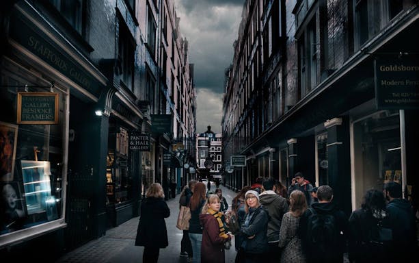 Group of tourists in a narrow London alley, exploring film locations.