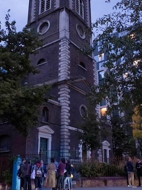 Tour group outside historic church on Jack the Ripper Tour in London.