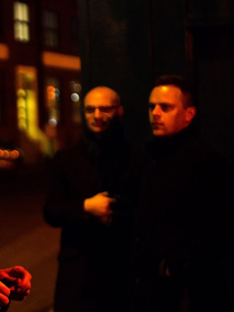 Tour guide leading Jack The Ripper & Haunted London Tour at night.