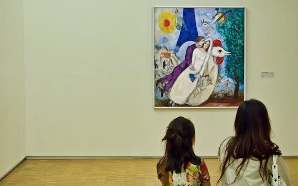 Visitors viewing a colorful painting at Centre Pompidou, Paris.