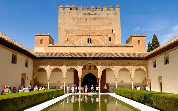 Alhambra's Nasrid Palaces courtyard with reflecting pool, Granada, Spain.