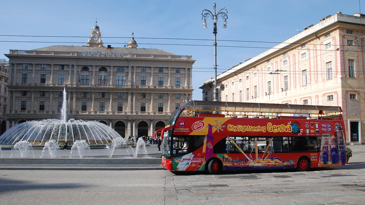 Genoa cityscape with red sightseeing bus on 24/48Hr Hop-On-Hop-Off City Sightseeing Genoa Tour.