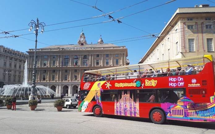 Open-top sightseeing bus in front of Palazzo della Regione, Genoa.
