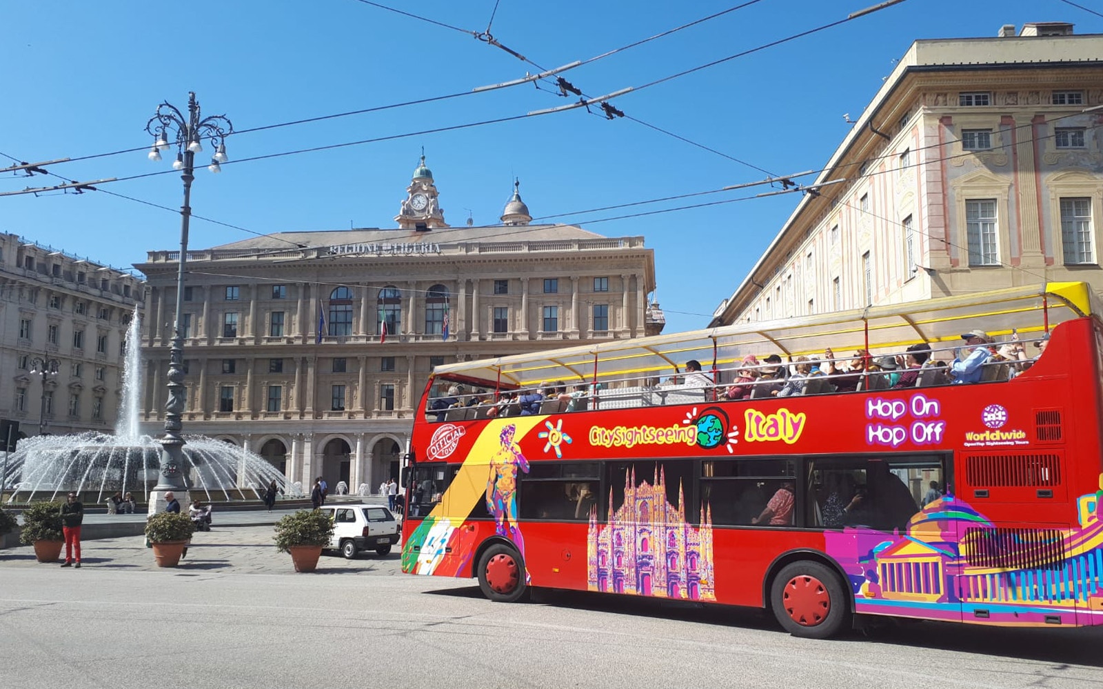 Genoa cityscape with red sightseeing bus on 24/48Hr Hop-On-Hop-Off City Sightseeing Genoa Tour.