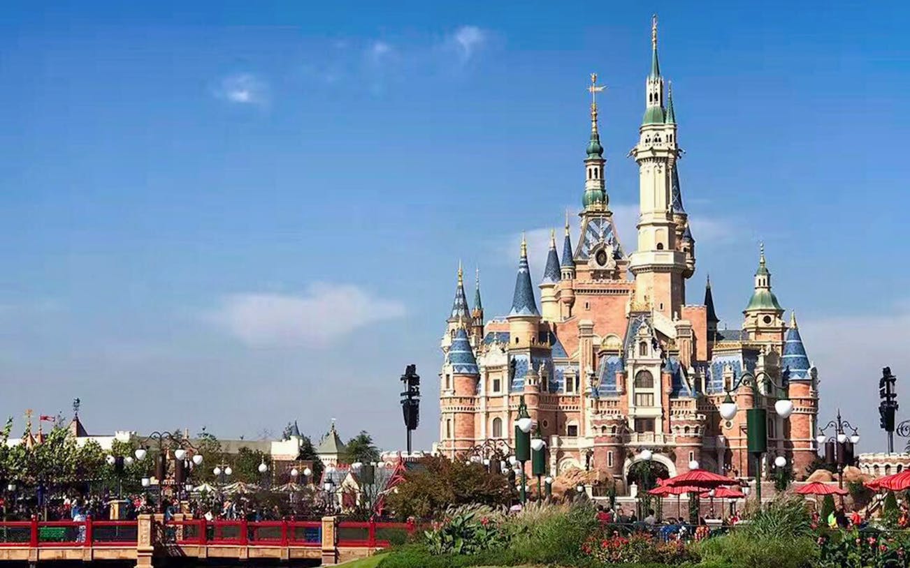 Shanghai Disneyland Enchanted Storybook Castle with visitors in the foreground.