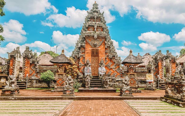 Balinese temple architecture at Goa Gajah, Ubud, with intricate stone carvings.