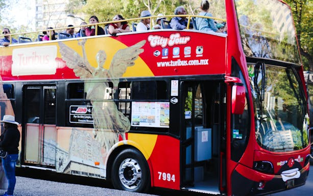 Turibus double-decker bus with passengers on a Mexico City tour.