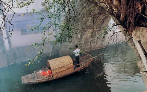 Boat on canal under bridge in Zhujiajiao Ancient Water Town, China.