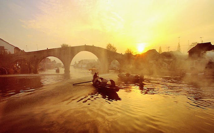 Boats on a canal at sunset in Zhujiajiao Ancient Water Town, China.
