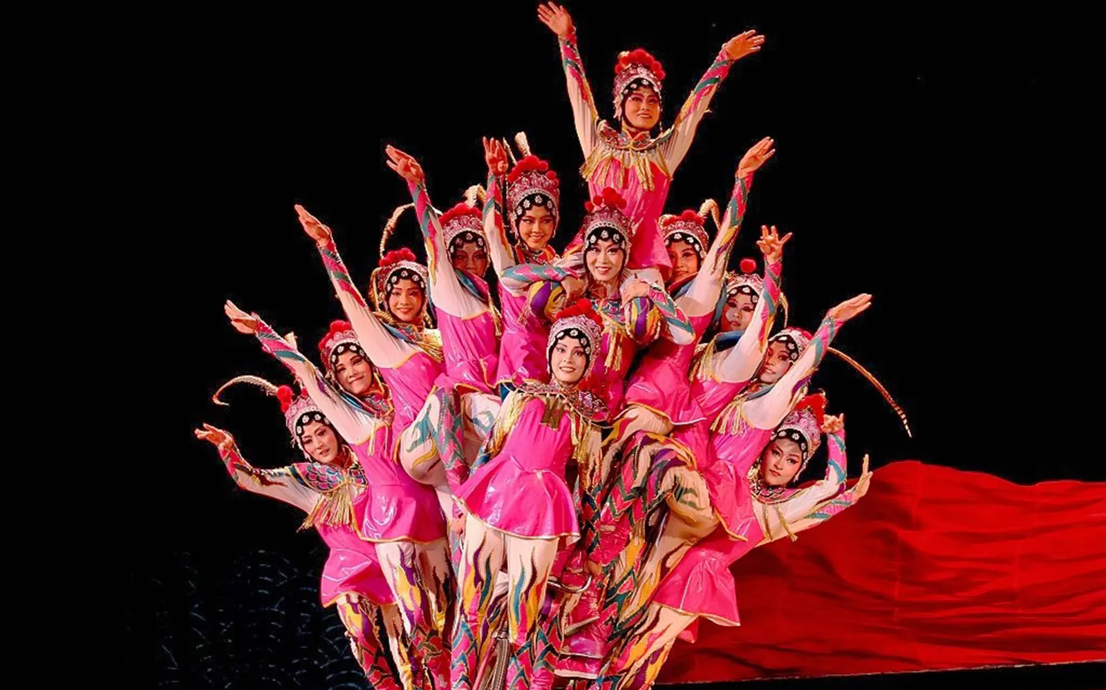 Acrobats in colorful costumes performing in Beijing show.
