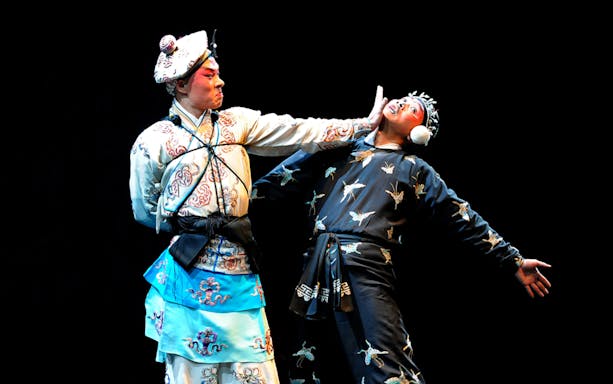 Performers in traditional costumes during a Peking Opera show at Beijing Liyuan Theatre.