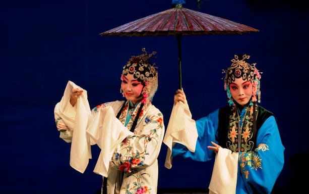 Performers in traditional Peking Opera costumes at Beijing Liyuan Theatre.