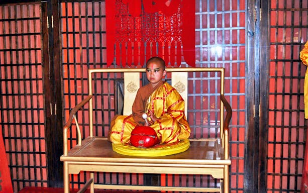 Young Shaolin monk in traditional attire at Beijing Red Theatre.