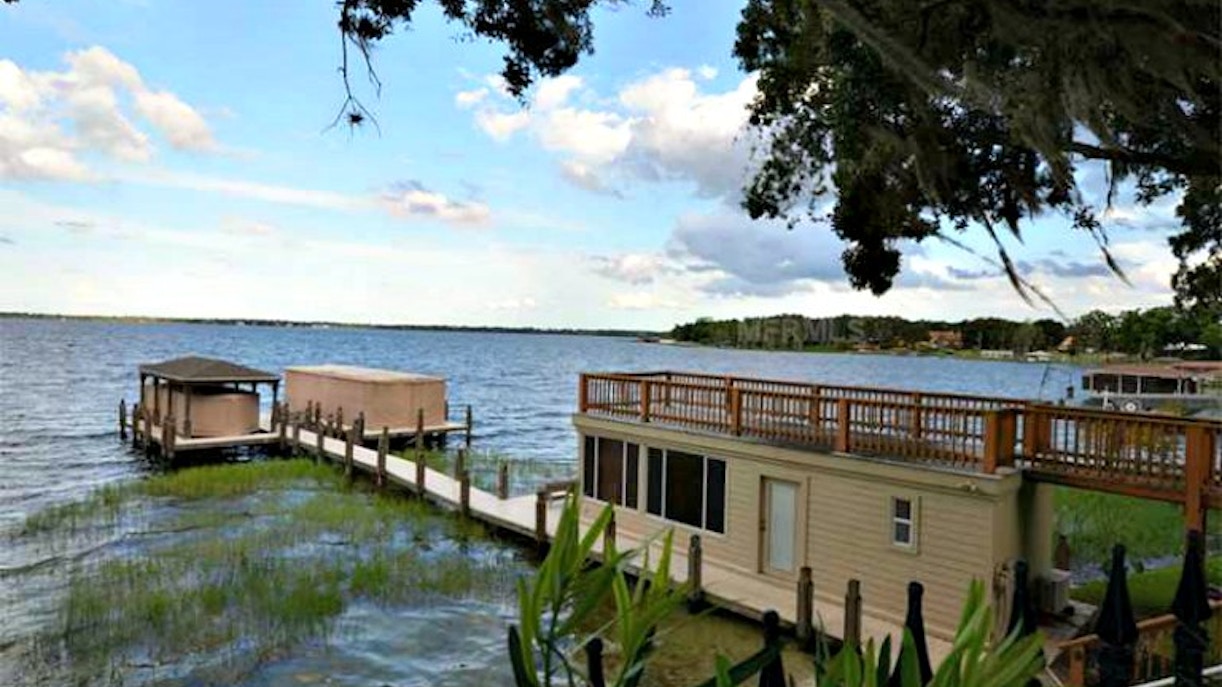 Lakefront view with docks and boathouse on the Celebrities of Orlando Boat Tour.
