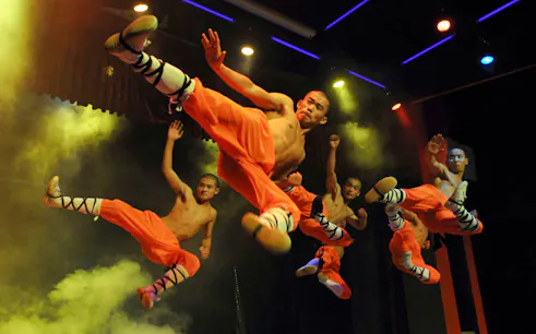 Shaolin monks performing martial arts during a Beijing Kungfu show.