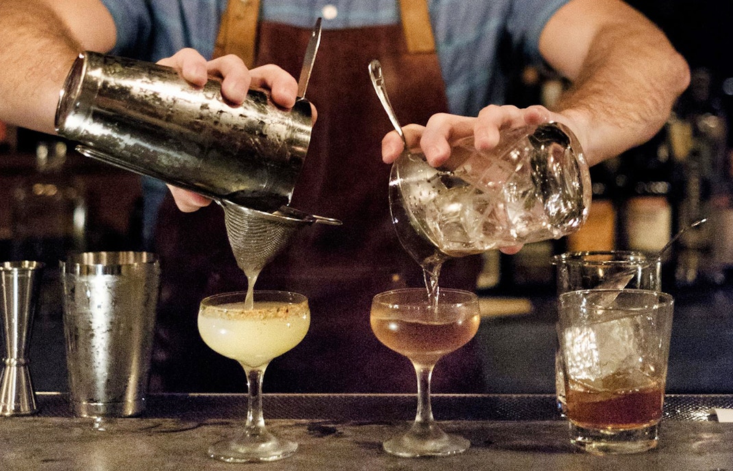 Bartender pouring cocktails
